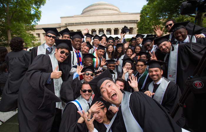 Image of graduates posing in front of Killian Court