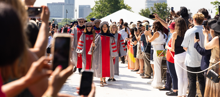 Image of the audience watching the academic procession make its way into Killian Court. 