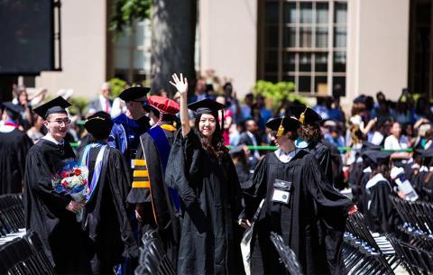 Students wave from the audience