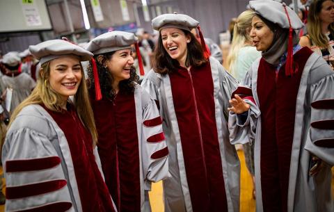 PhD Candidates assemble in Rockwell Cage in preparation for the Hooding Ceremony