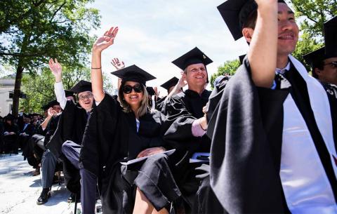 Graduates wave from the audience