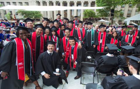 Image of a group of graduates posing in front of the stage on Killian Court at the Special Ceremony for the Classes of 2020 and 2021