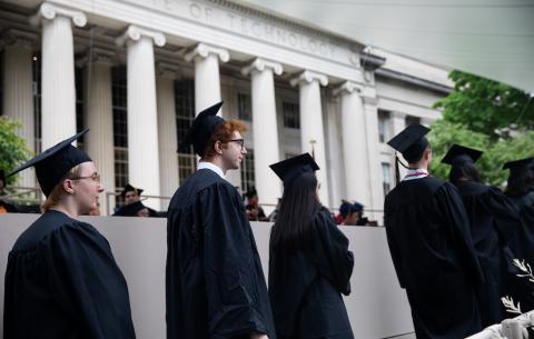 Image of students in front of Building 10 waiting to receive their Congratulations scroll