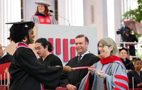 Image of President Sally Kornbluth handing Adanna Abraham-Igwe her diploma case